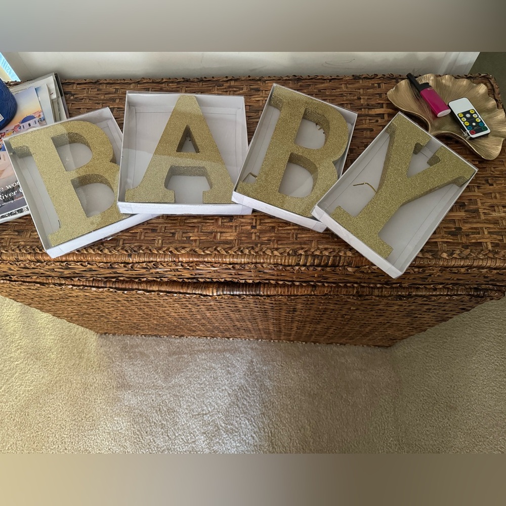 Gold glitter letters to spell out BABY